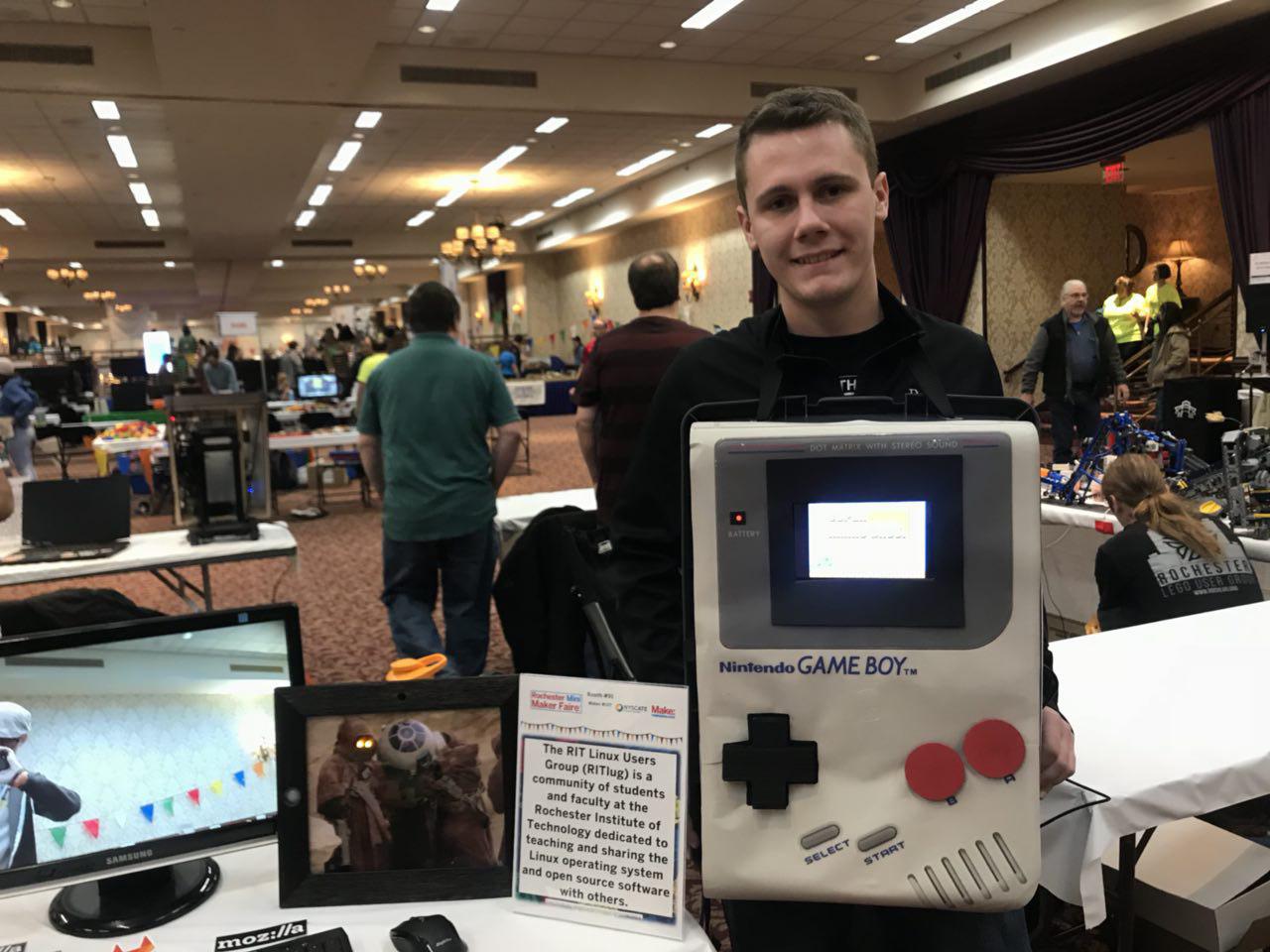 Taylor Bowling stands next to the Spy Pi, a discreet picture frame that takes a picture when it detects movement at the Rochester Mini Maker Faire 2017
